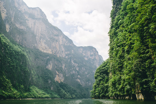 Scenic valley view of canyon and lake surrounded by vegetation in Chiapas, Mexico.