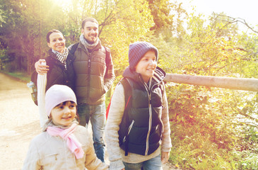 happy family with backpacks hiking