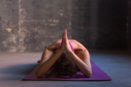 Woman practicing yoga in a studio