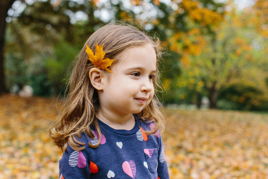 Cute young girl with a leaf behind her ear