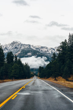 Highway in showing a mountain range covered in snow