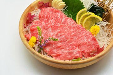 Close up wagyu set on ice in brown wooden bowl and on white background