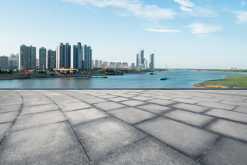 empty marble floor and cityscape of nanchang in blue cloud sky