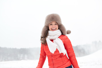 Obraz premium happy woman in winter fur hat outdoors