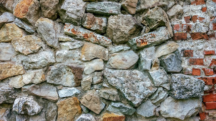 Stone old wall from huge blocks. Background of stones. The concept reliability. The space between stones is filled with cement.