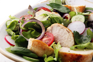 Chicken salad with leaf vegetables and cherry tomatoes.