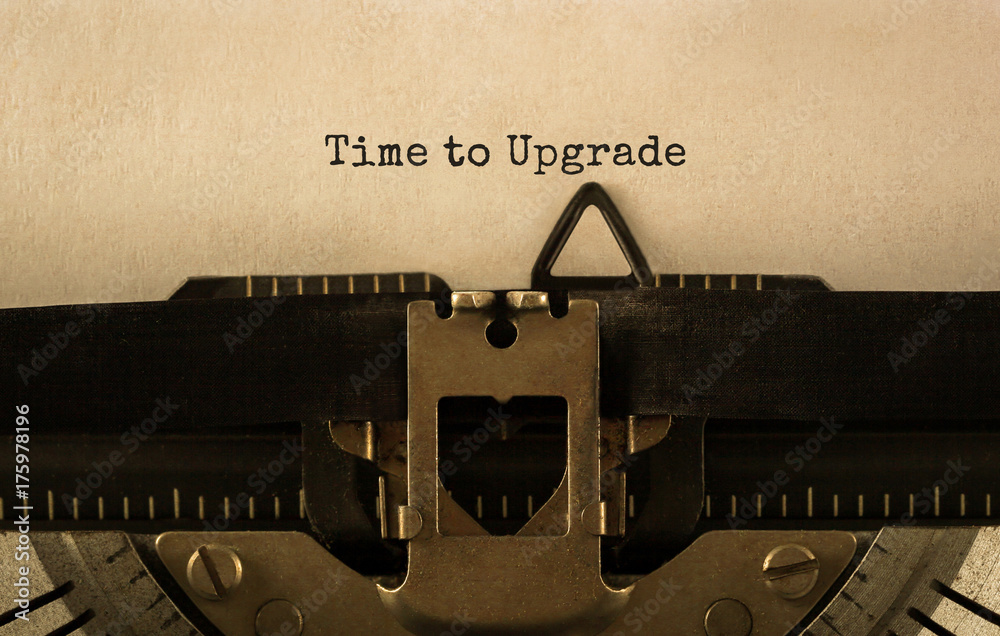 Poster text time to upgrade typed on retro typewriter