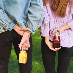 Time to detox. Youth with fruit juice cocktails on green summer nature background. Vegetarian lifestyle, fitness food on the go concept