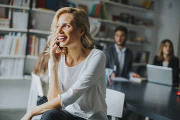 Businesswoman using mobile phone in office