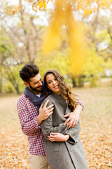 Fototapeta premium Lovely young couple in the autumn forest