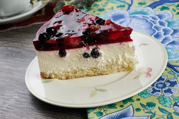 Slice of delicious tasty cheesecake with berry