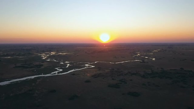 Aerial shot of winding river at sunset in the Okavango Delta