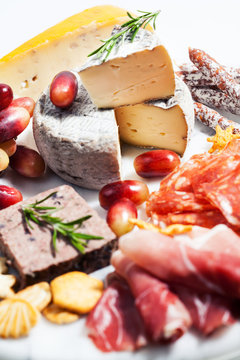 Food tray with charcuterie assortment, cheese  and grapes