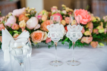 table serving with glasses and flowers in hall