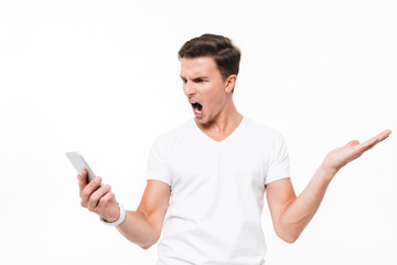 Portrait of an angry furious man in white t-shirt