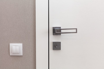 Obraz premium Close white door with metallic handle. The door to the bedroom