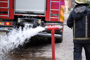 The fireman opens a fire hydrant to extinguish a fire