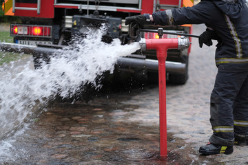The fireman opens a fire hydrant to extinguish a fire
