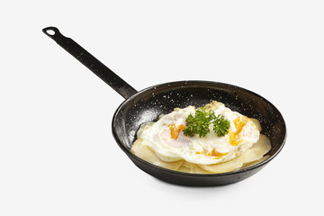 fried eggs with fries on black pan