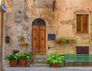 Fototapeta na wymiar Traditional façade of Italian house in the small magical and old village of Pienza, Val D'Orcia Tuscany – Italy