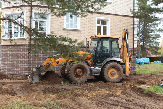 Tractor JCB is working.
