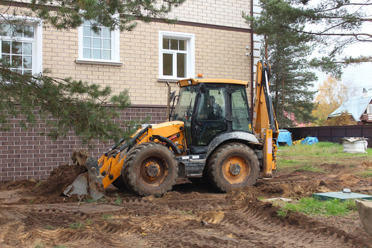 Tractor JCB is working.
