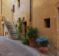 Fototapeta na wymiar Traditional façade of Italian house in the small magical and old village of Pienza, Val D'Orcia Tuscany – Italy
