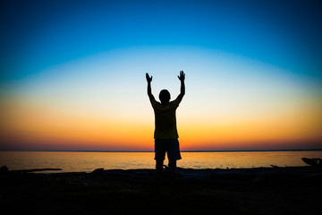 Fototapeta premium Person Praying at Sunset