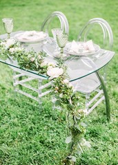 decorated wedding table for two with beautiful flower composition of flowers, glasses for wine, outdoor, fine art.