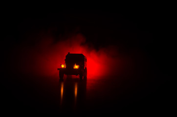 Truck in the conflict zone. The war in the countryside. War vehicle silhouette at night. Battle...