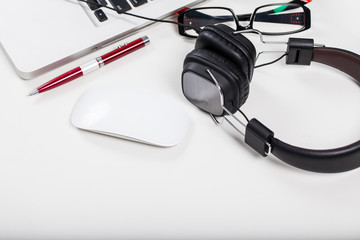 Table office with red pen, Mouse, notebook and hearphone.
