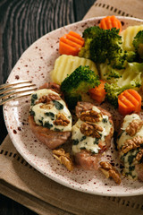 Pork tenderloin baked with blue cheese and stewed vegetables.