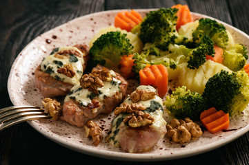 Pork tenderloin baked with blue cheese and stewed vegetables.