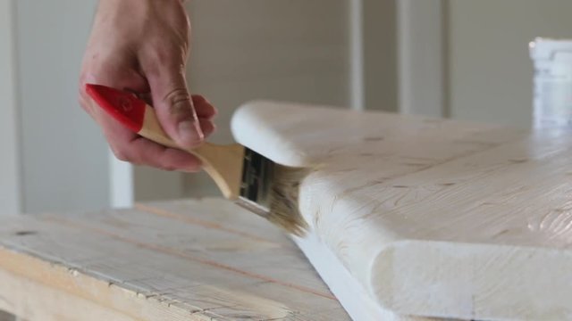 Impregnation of diagonally arranged wooden step with a brush.