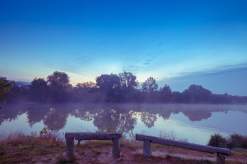 Early in the morning, dawn over the lake. Calm lake before sunrise. A misty morning, a rural landscape, a desert, a mystical feeling