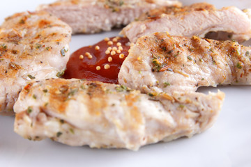 Steaks with grill on a white plate with a wooden fork, tomato sauce, spices and grains of mustard on a dark blue background in retro style