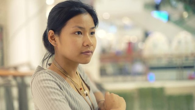 Portrait of Pretty Asian Girl in shopping center. Cross processed toned video 4k UHD (3840x2160)
