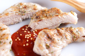Steaks with grill on a white plate with a wooden fork, tomato sauce, spices and grains of mustard on a dark blue background in retro style