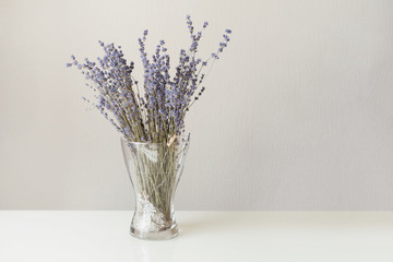 Lavender in glass vase on the white table