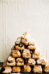 Strudel Apple and sugar powder. Biscuit from the puffed Test on the Gray Background. Dessert with Fruits.Copy space for Text. selective focus.