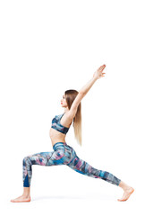 Portrait of a blonde woman in the Virabhadrasana position against a white background