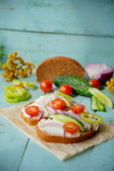 Sandwich with herb pesto and edible nasturtium flowers