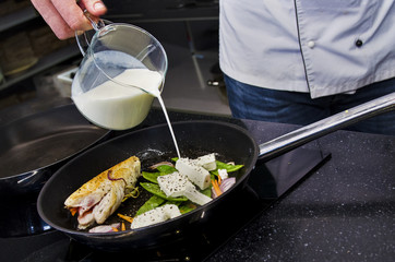 Chef preparing dishes in a frying pan