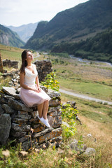 Naklejka na ściany i meble Young woman near a stone wall