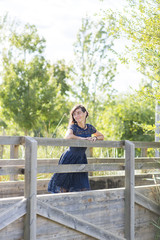 Naklejka premium Portrait of a sensual woman on a wooden bridge