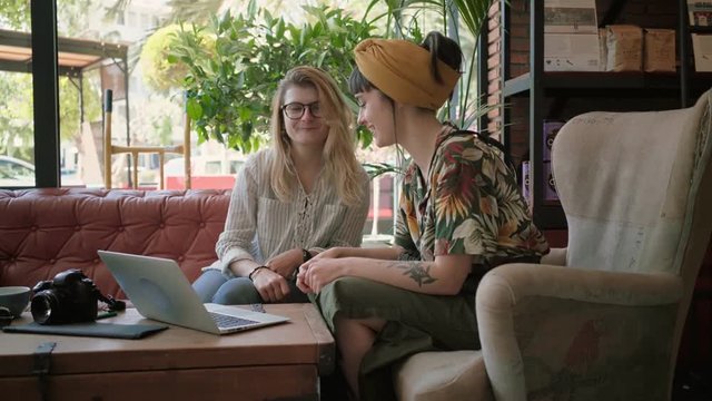 Siblings call parents on video call, or two young freelancers finish business meeting through online chat, wave to partners or family members, laugh and smile to laptop, concept happy, long distance