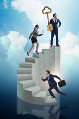 Businessman with key to success at the top of career 