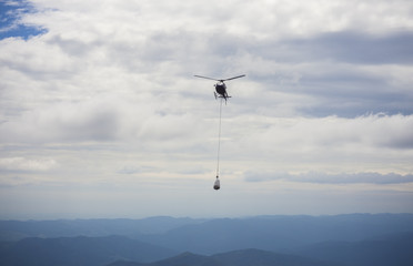 Fototapeta na wymiar helicopter carry cargo in the sky