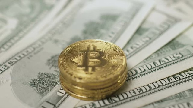Pile of bitcoins on dollars