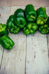 Green peppers on table.